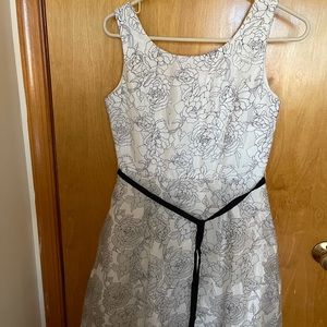 Brand new beautiful white dress with black floral details.